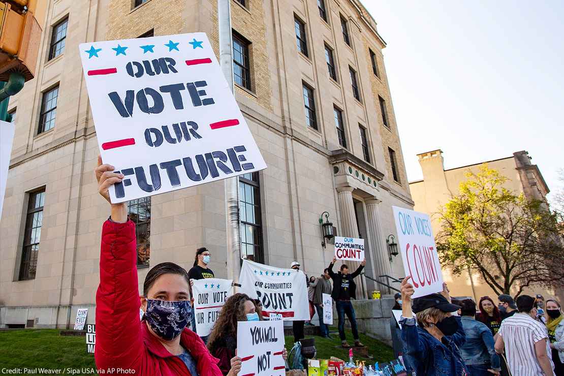 Dozens of people gathered near the Post Office in Lewisburg, Pennsylvania, holding signs that read "Our Vote Our Future" and "Our Voices Count," to celebrate the election of Joe Biden.