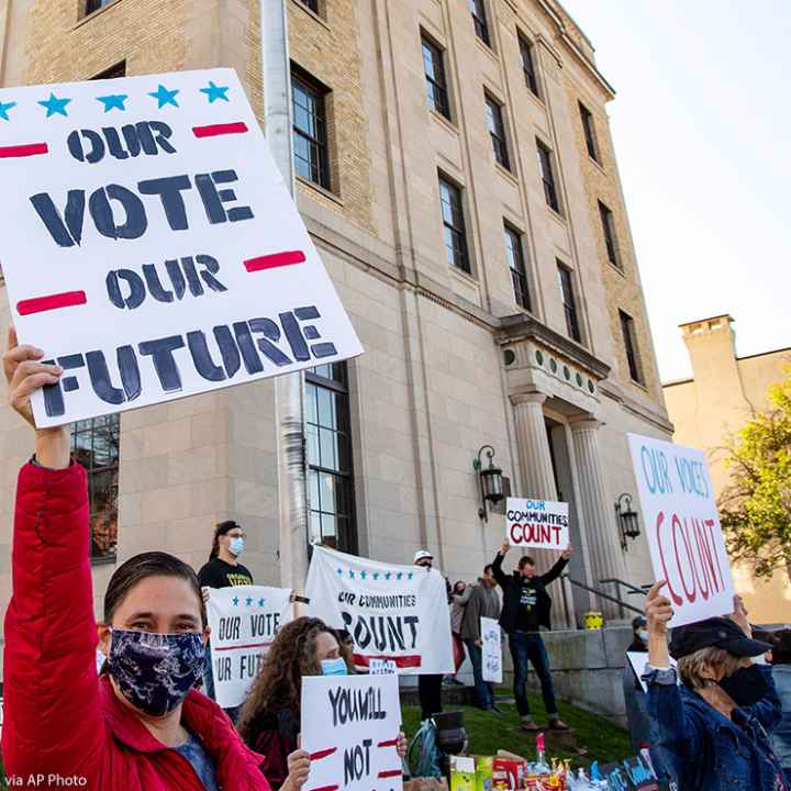 Dozens of people gathered near the Post Office in Lewisburg, Pennsylvania, holding signs that read "Our Vote Our Future" and "Our Voices Count," to celebrate the election of Joe Biden.